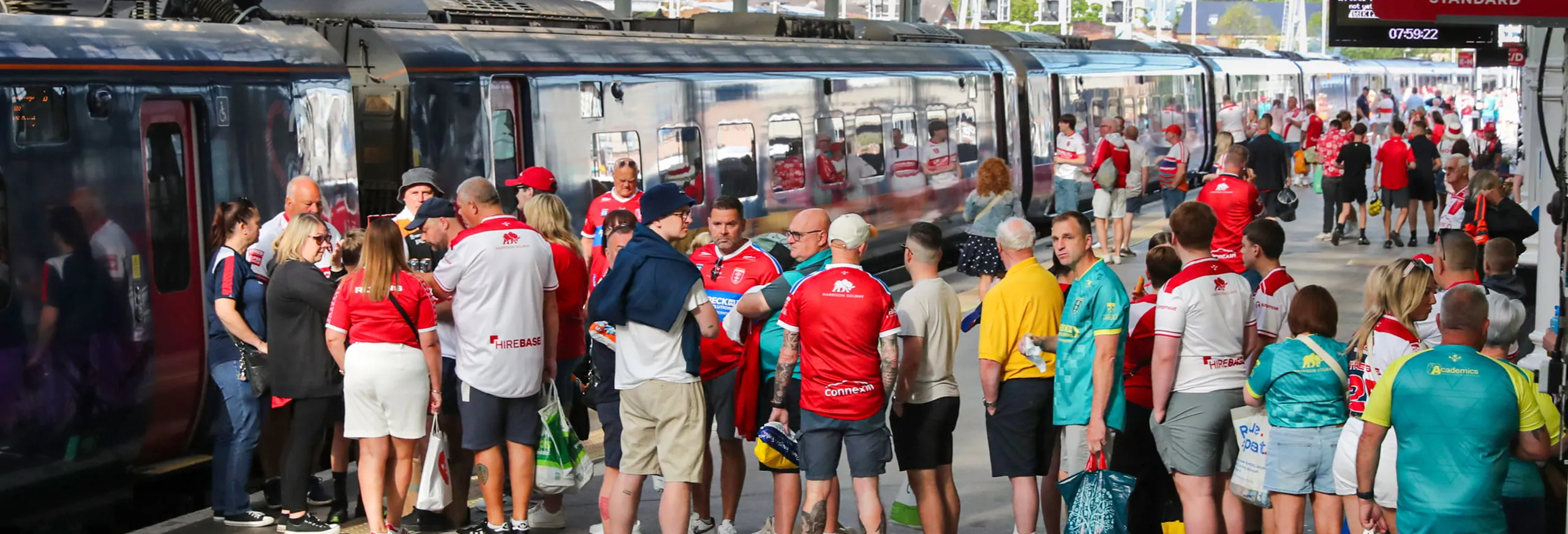 A photo of sports fans on the platform waiting to board a Hull Trains service