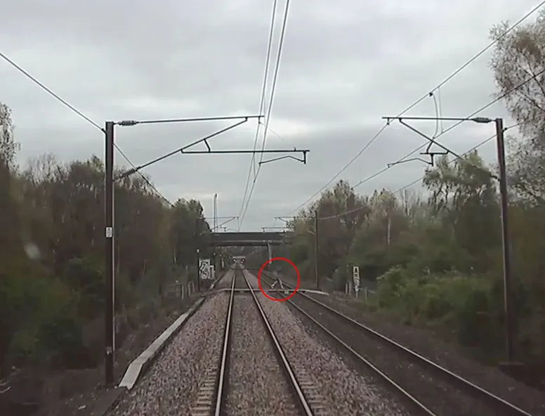 A person circled crossing train tracks as a train is approaching at 100mph