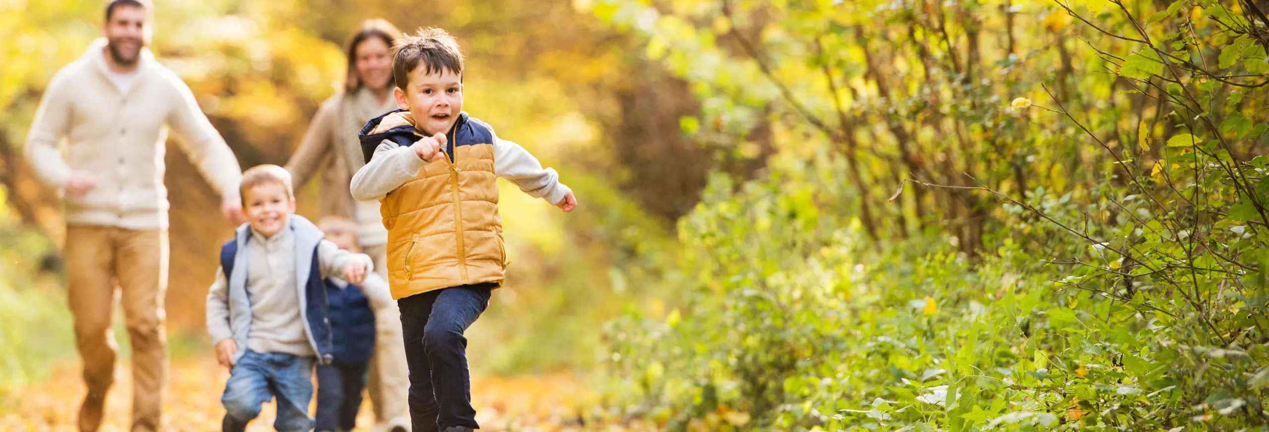 Family running outdoors in Autumn
