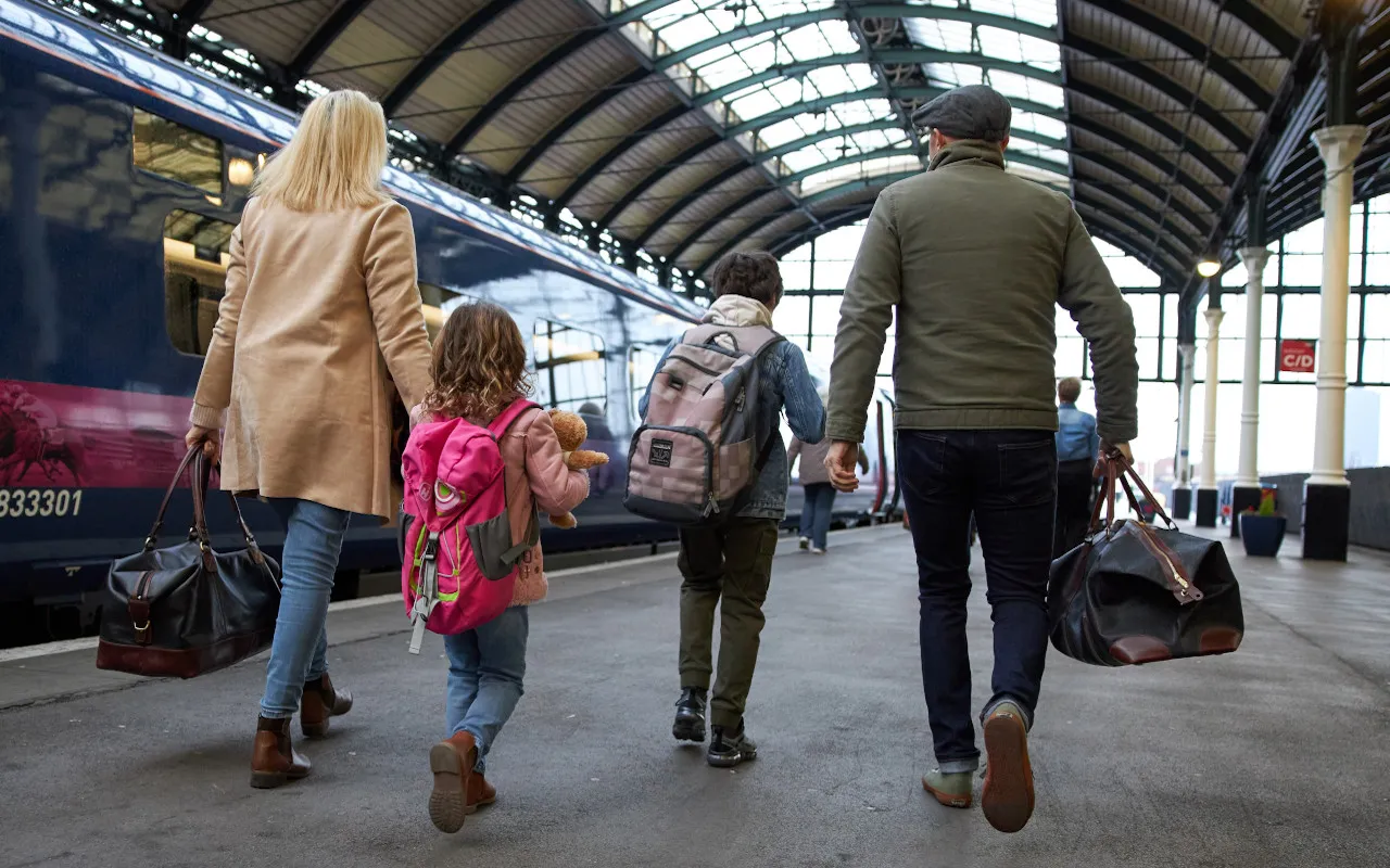 Family on station platform by Hull Trains Paragon